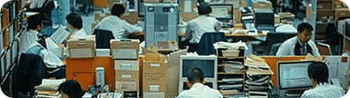 Image of a busy, crowded, and messy legacy office setup